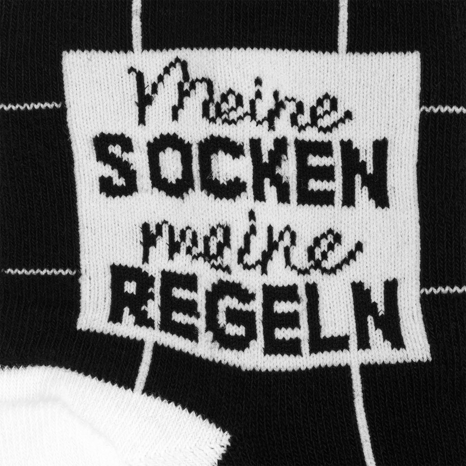 Schwarz-weiße Zaubersocken mit Schriftzug Meine Socken Regeln