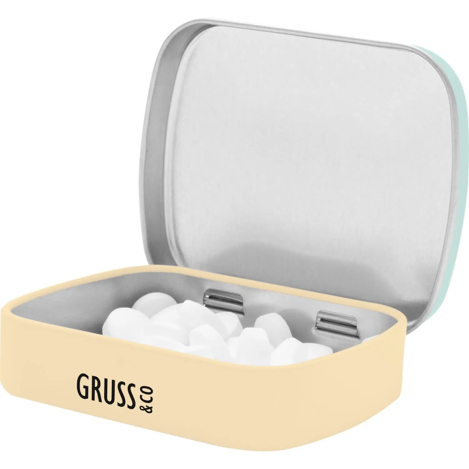 Beigefarbene Metall-Mintdose mit offenem Deckel und weißen Pastillen.