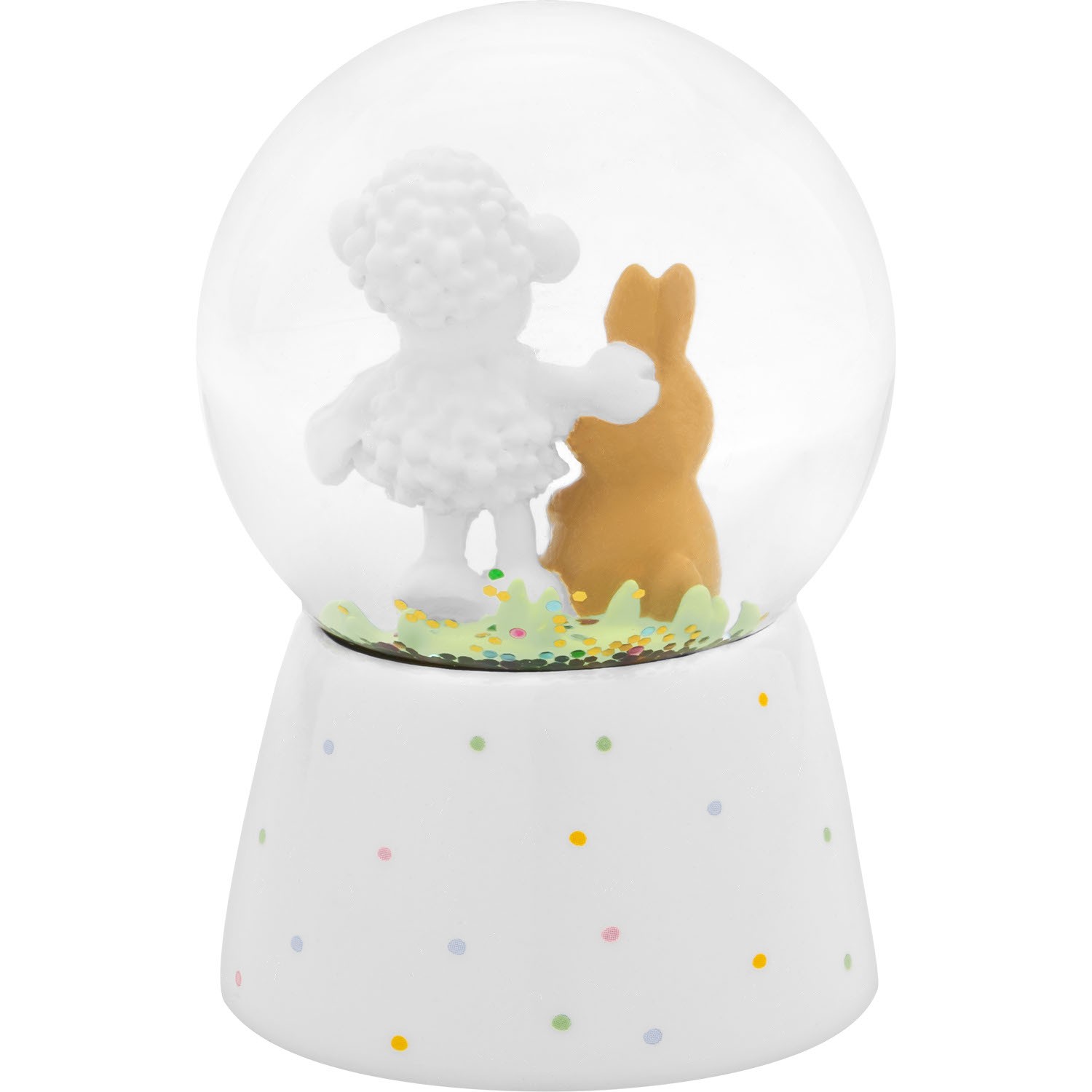 Schneekugel mit Schäfchen und Hasen-Figur auf weißem Sockel, bunte Punkte im Glas
