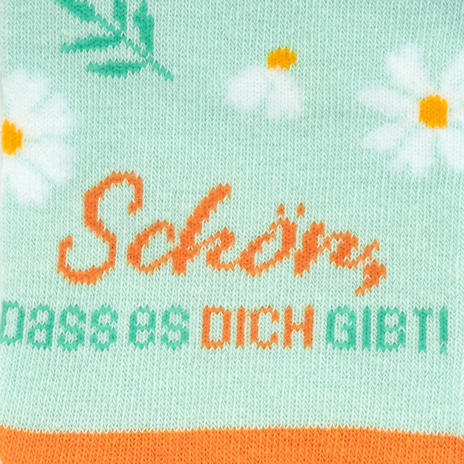 Mintgrüne Socke mit Gänseblümchen-Muster und orangefarbenem Schriftzug