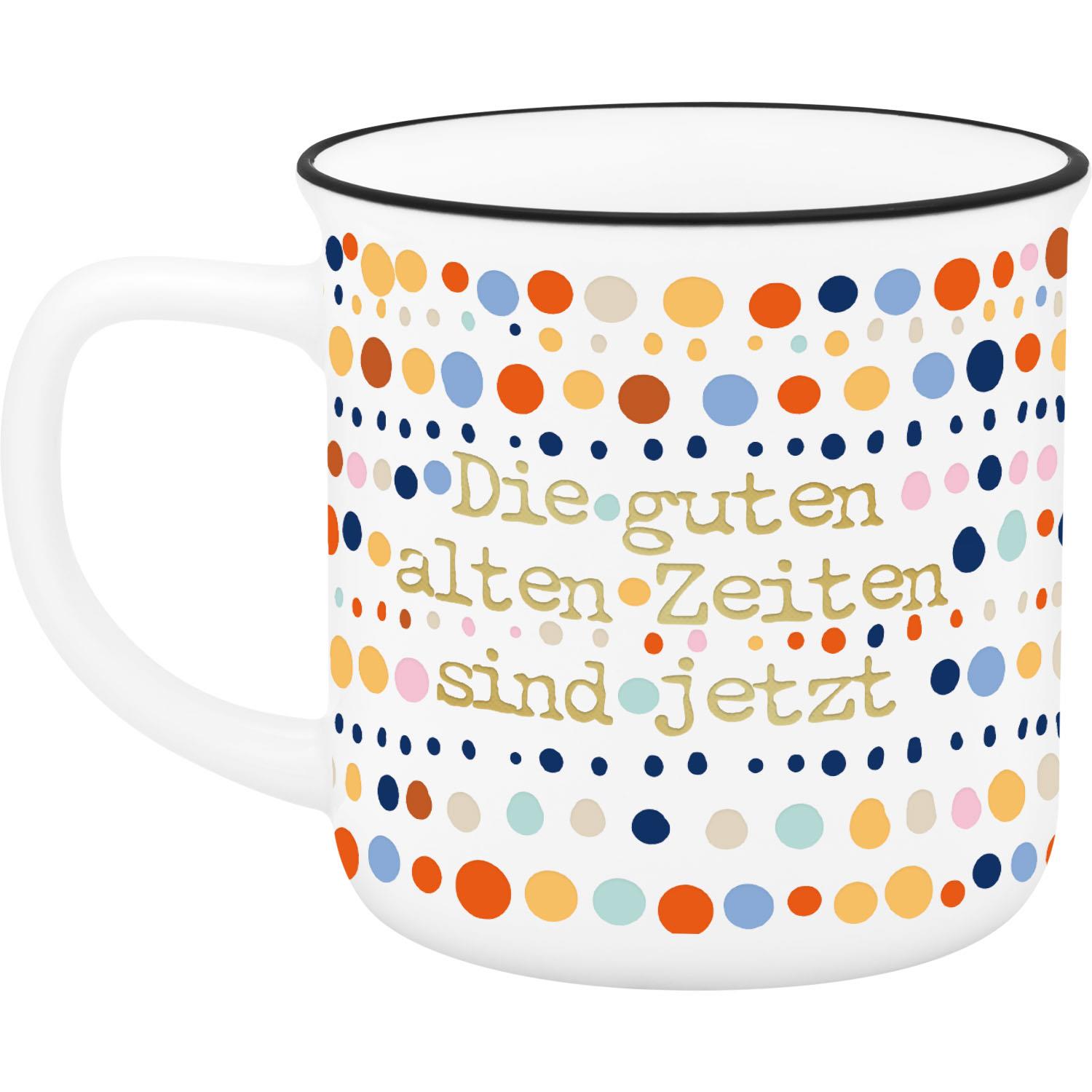 Weißer Becher mit bunten Punkten und Goldschrift