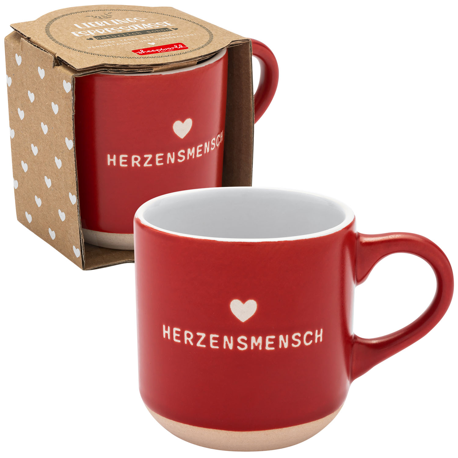 Rote Keramik-Tasse mit Herzmotiv und Aufdruck HERZENSMENSCH vor Geschenkverpackung.