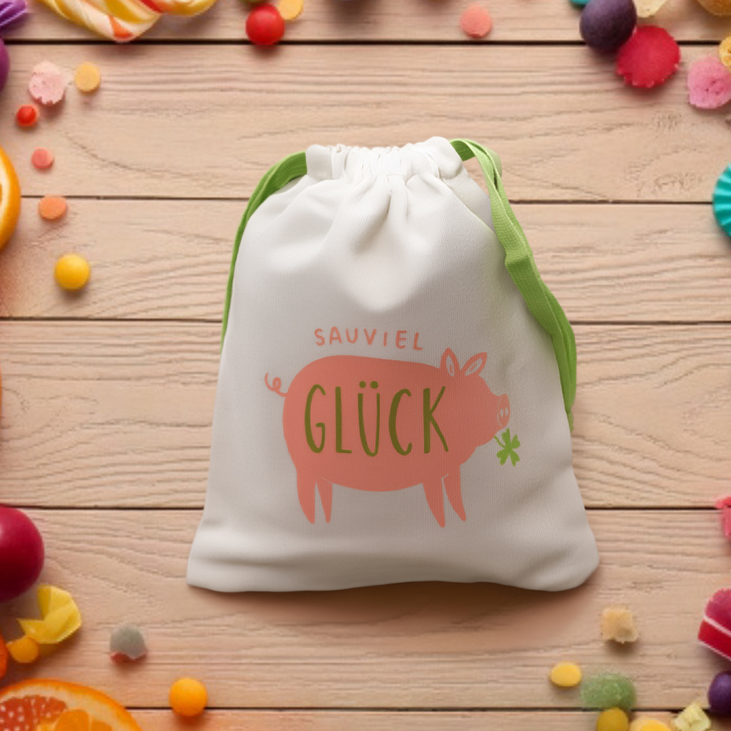 Weißes Canvas-Geschenksäckchen mit pinkem Glück-Schwein-Motiv und grünem GLÜCK-Schriftzug.