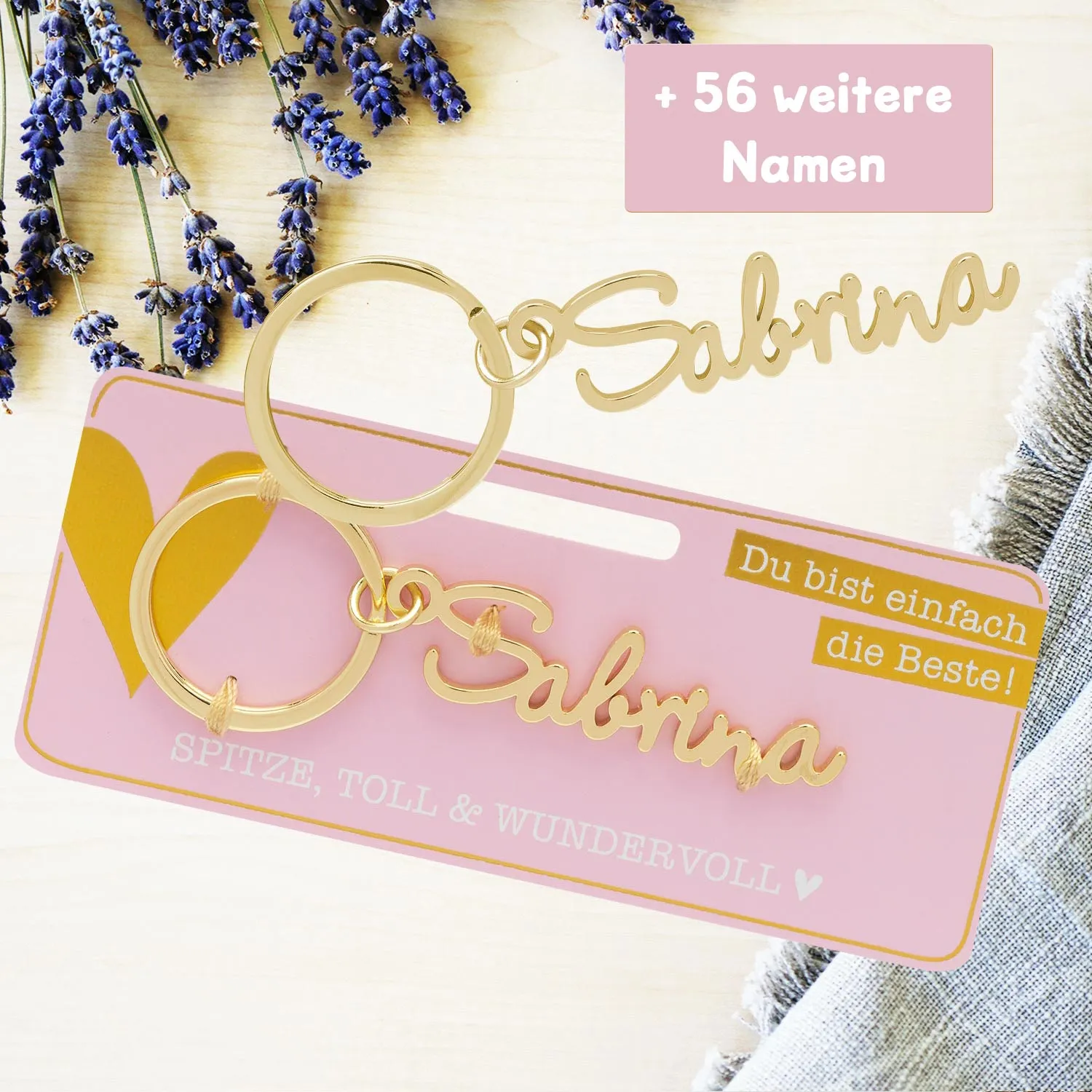 Namens-Schlüsselanhänger Sabrina aus Edelstahl mit goldener Schrift auf rosafarbener Karte