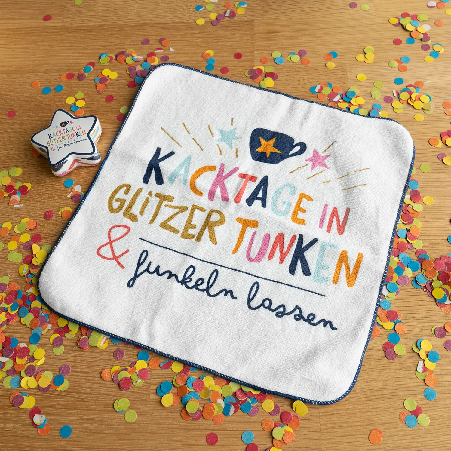 Weißes Zauberhandtuch mit buntem Schriftzug und Sternenmotiv