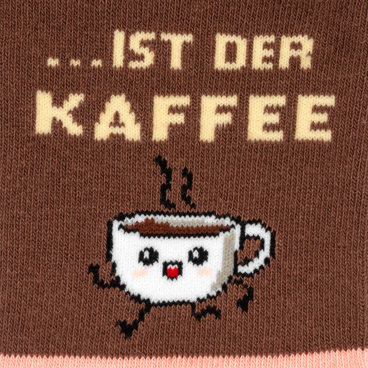 Braune Stricksocke mit weißer Kaffeetassen-Gesicht-Motiv