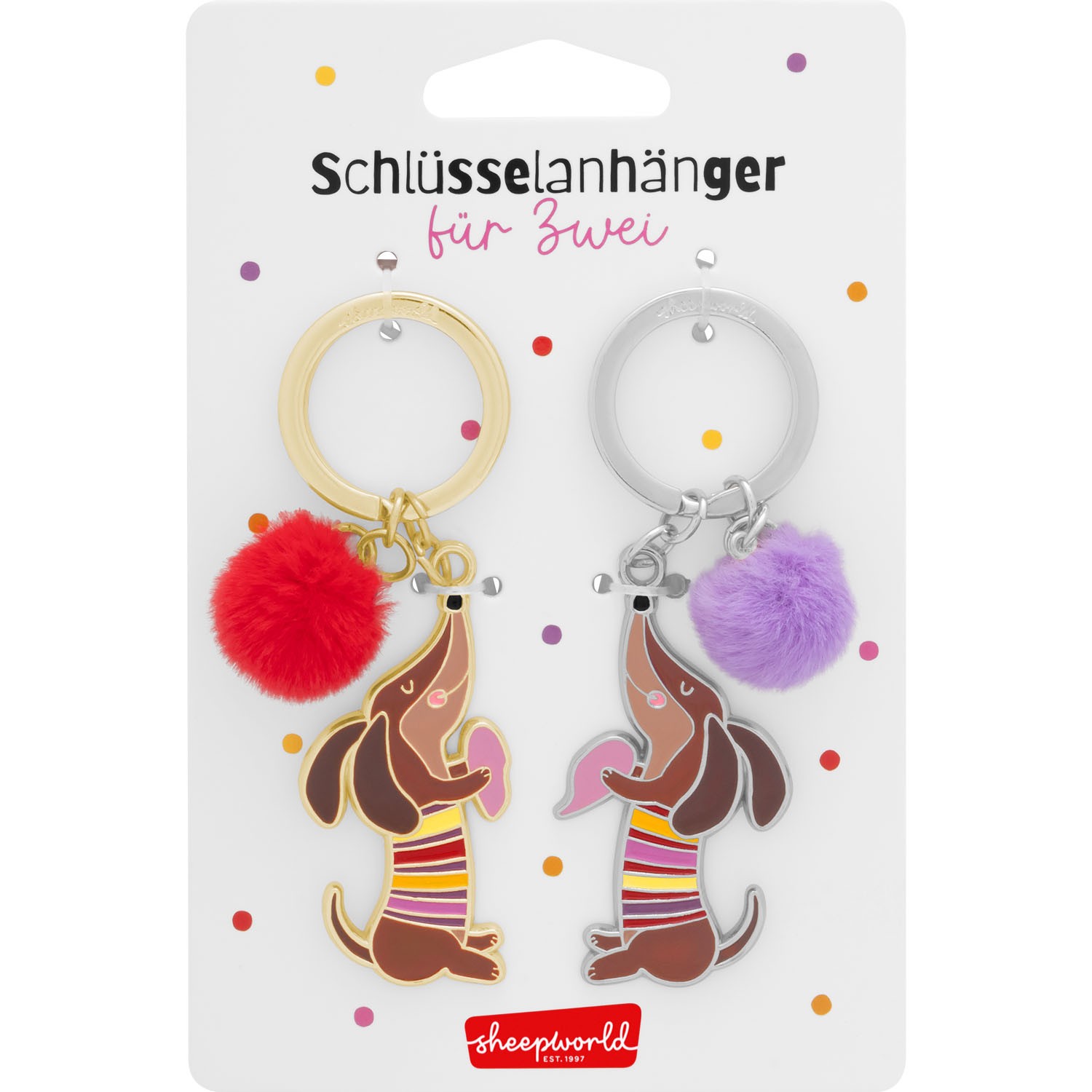 Zwei Dackel-Schlüsselanhänger mit bunten Streifen und plüschigem Pompon, Gold- und Silberring.