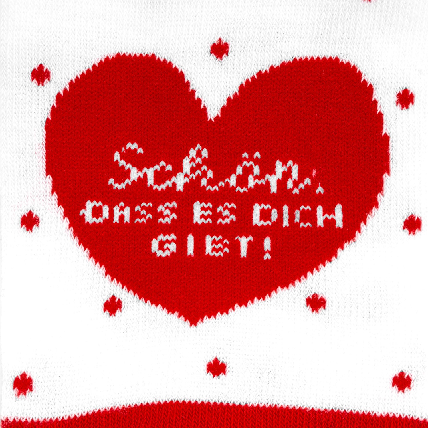 Zaubersocken in Herzform mit rotem Herzmotiv und der Botschaft 'Schön, dass es Dich gibt!'.