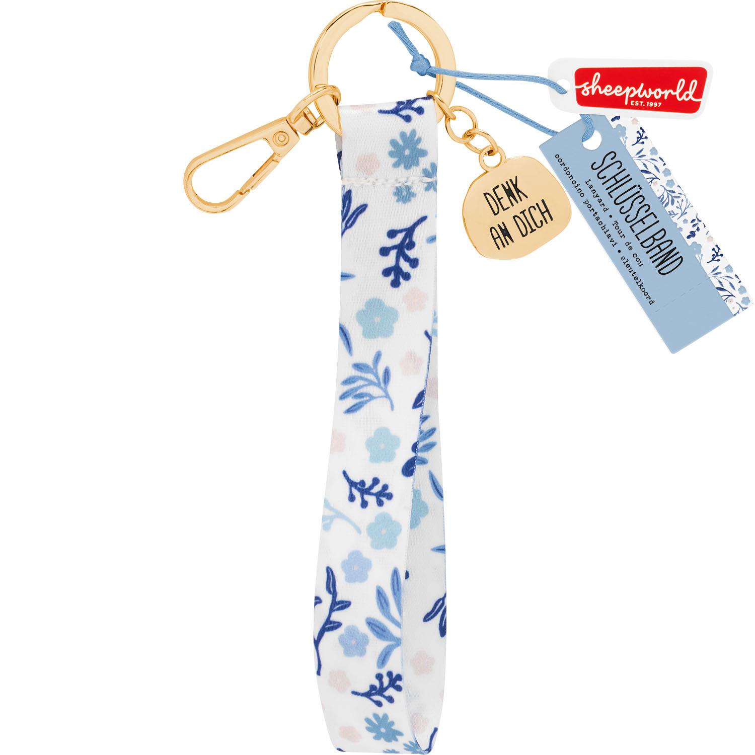 Floral gemustertes Schlüsselband mit goldener Ring-Schließe und Herz-Anhänger 'Denk an Dich'.