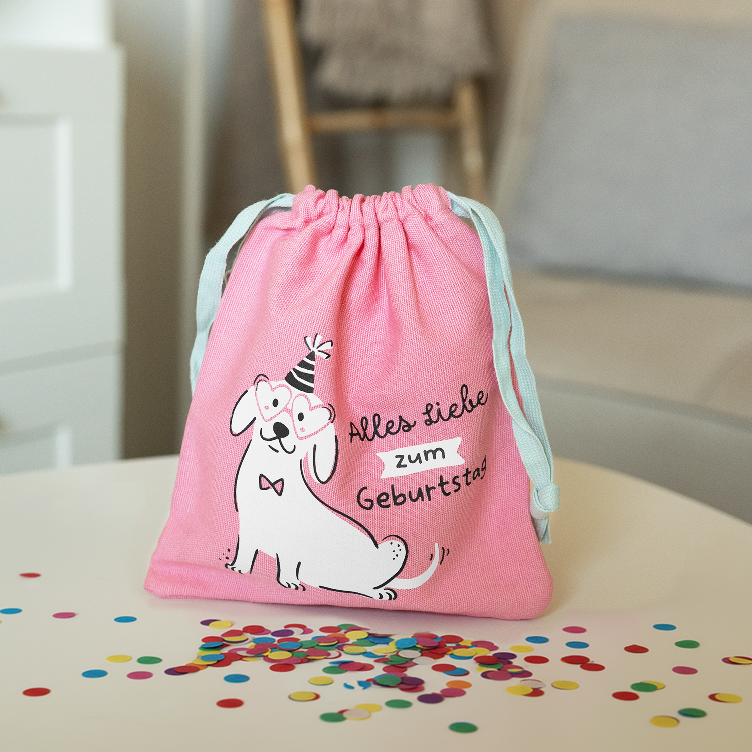 Rosa Geschenksäckchen mit Hundemotiv und Partyhut, ideal für Geburtstags-Geldgeschenke.