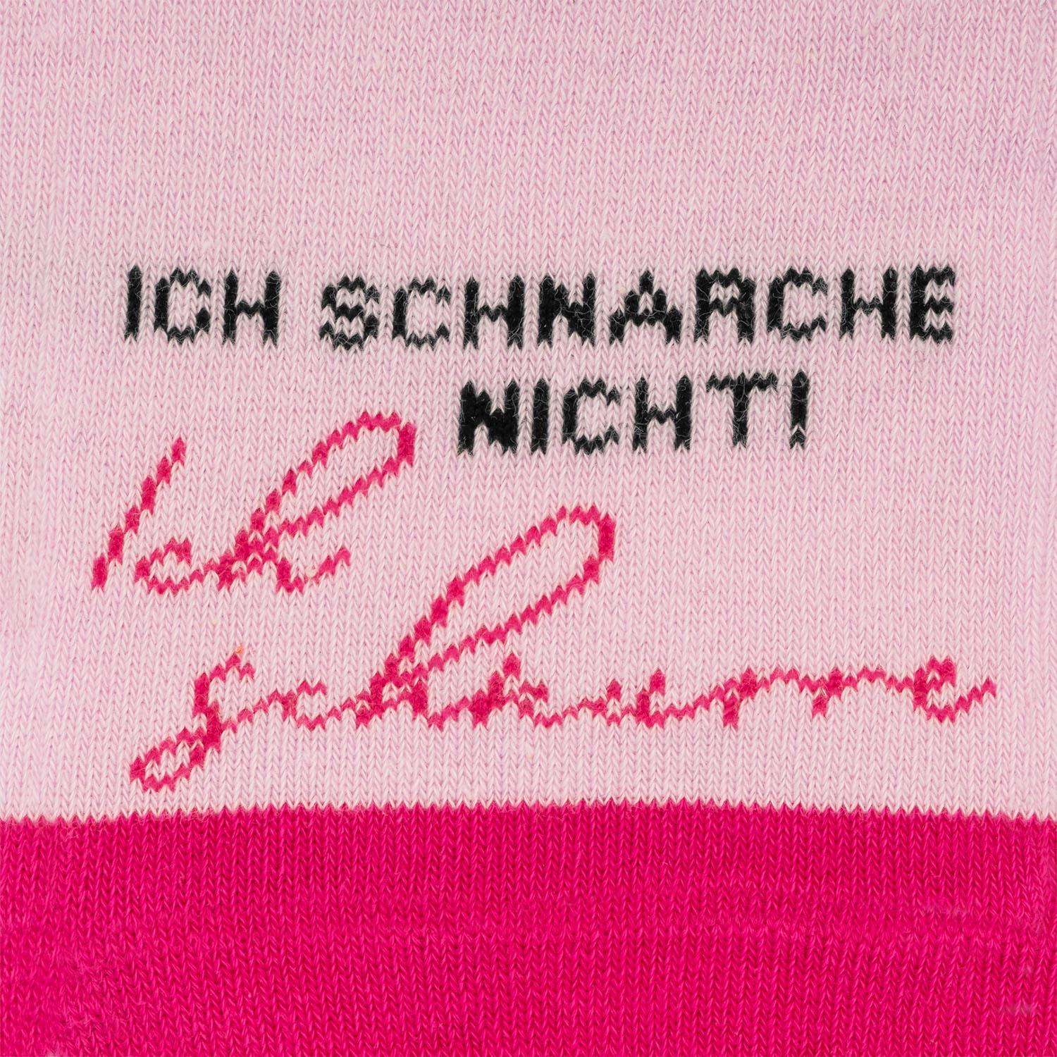 Rosa Stricksocke mit schwarzem Aufdruck Ich schnurre.