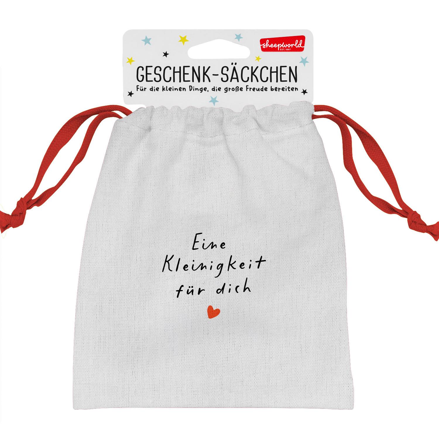 Weißes Canvas-Geschenk-Säckchen mit rotem Zugband und Schriftzug 'Eine Kleinigkeit für dich'.