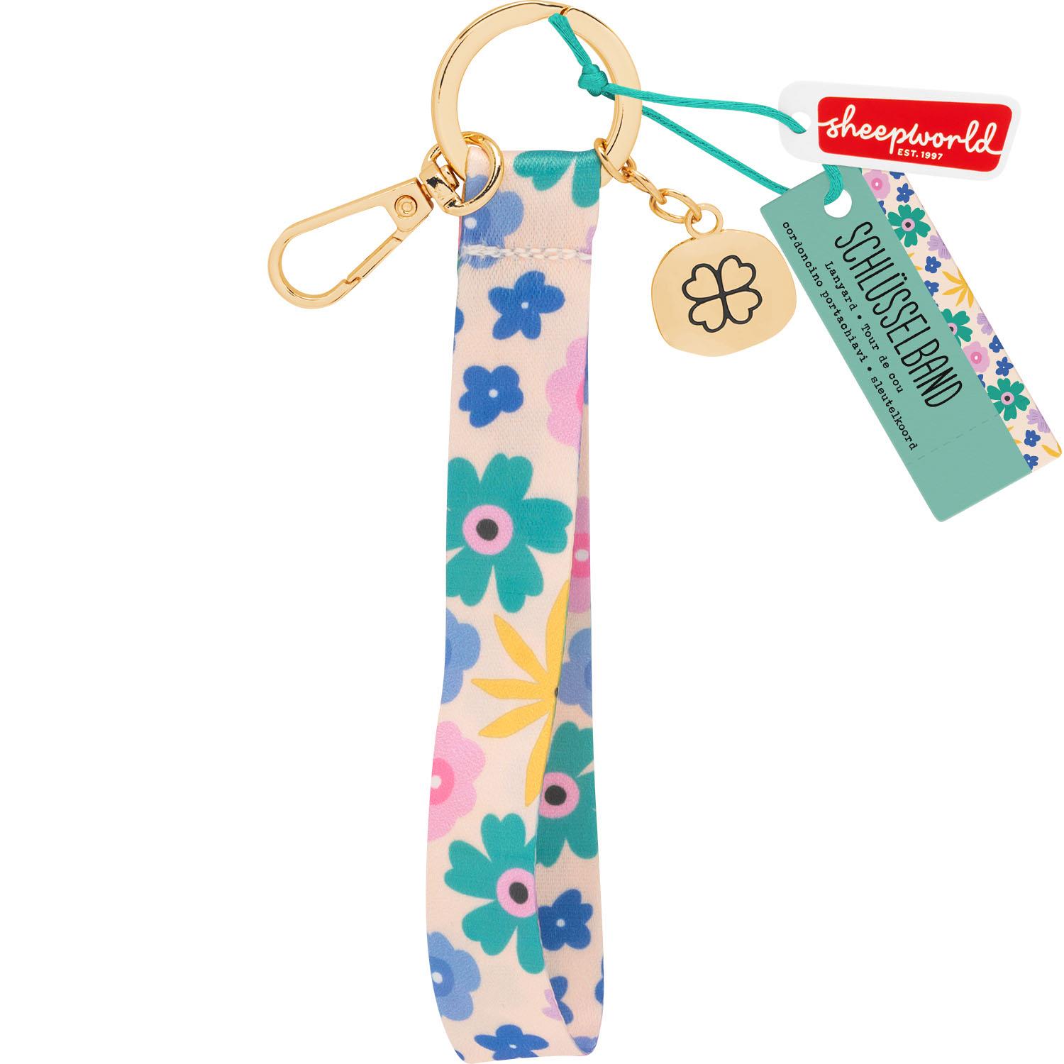 Floral gemustertes Schlüsselband aus Polyester mit goldenem Karabiner und Kleeblatt-Anhänger.