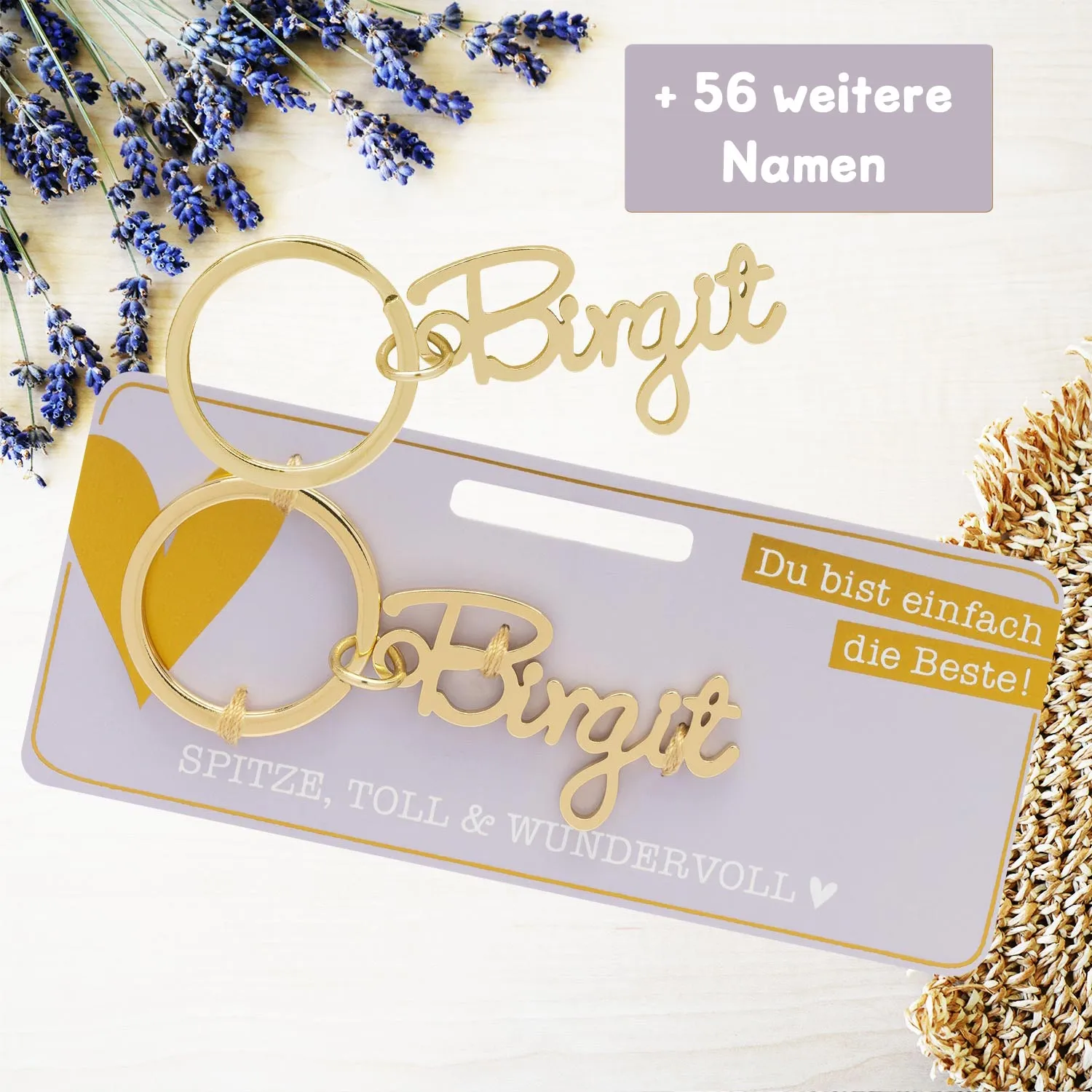 Goldfarbener Namensschlüsselanhänger Birgit auf pastell-lila Headerkarte.