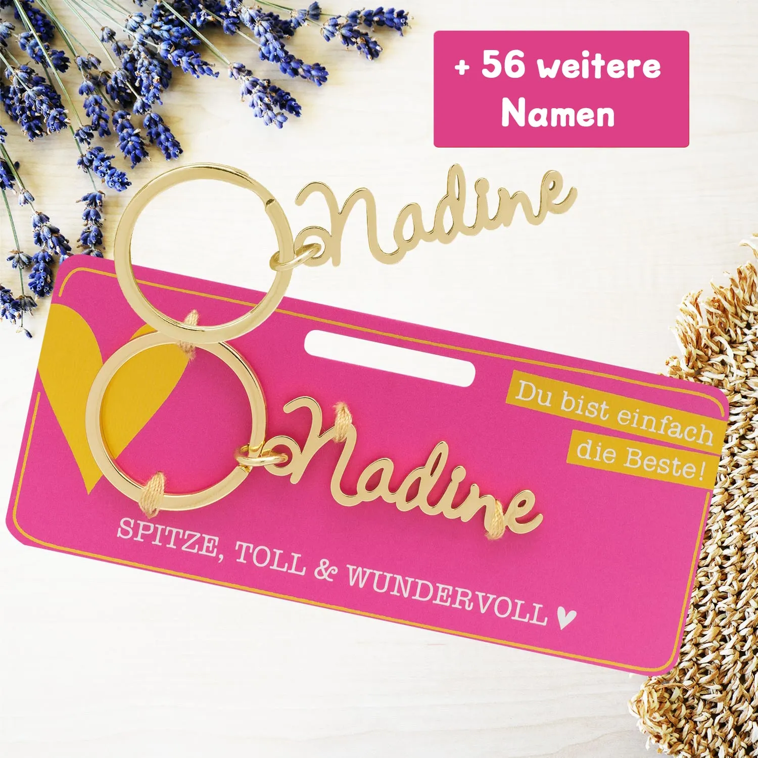 Namens-Schlüsselanhänger Nadine in Gold auf pinker Karte