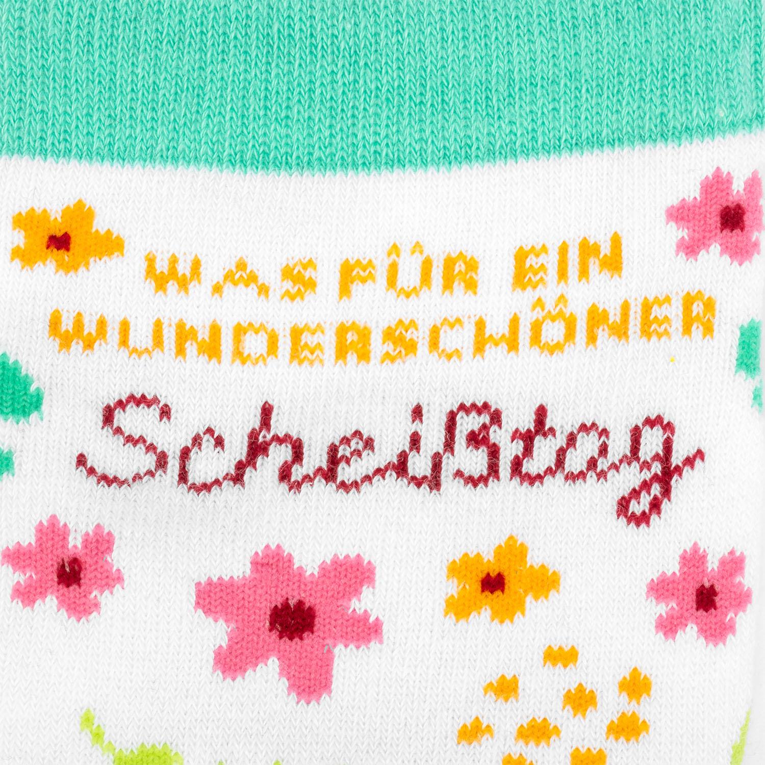 Weiße Socke mit Pastellblumenmuster in Pink und Mintgrün, Schriftzug in Orange