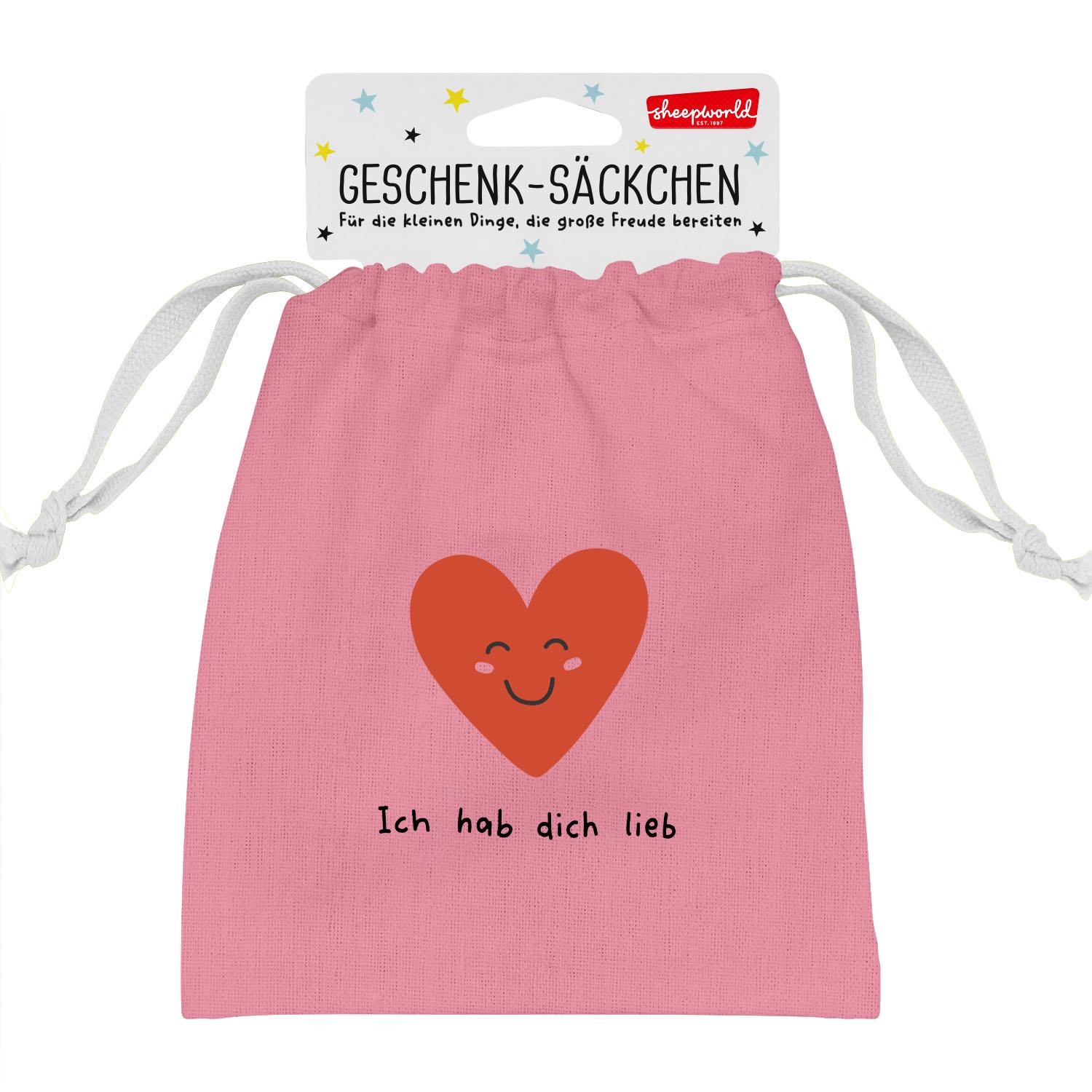 Pinkes Geschenksäckchen mit rotem Herz und freundlichem Gesicht.