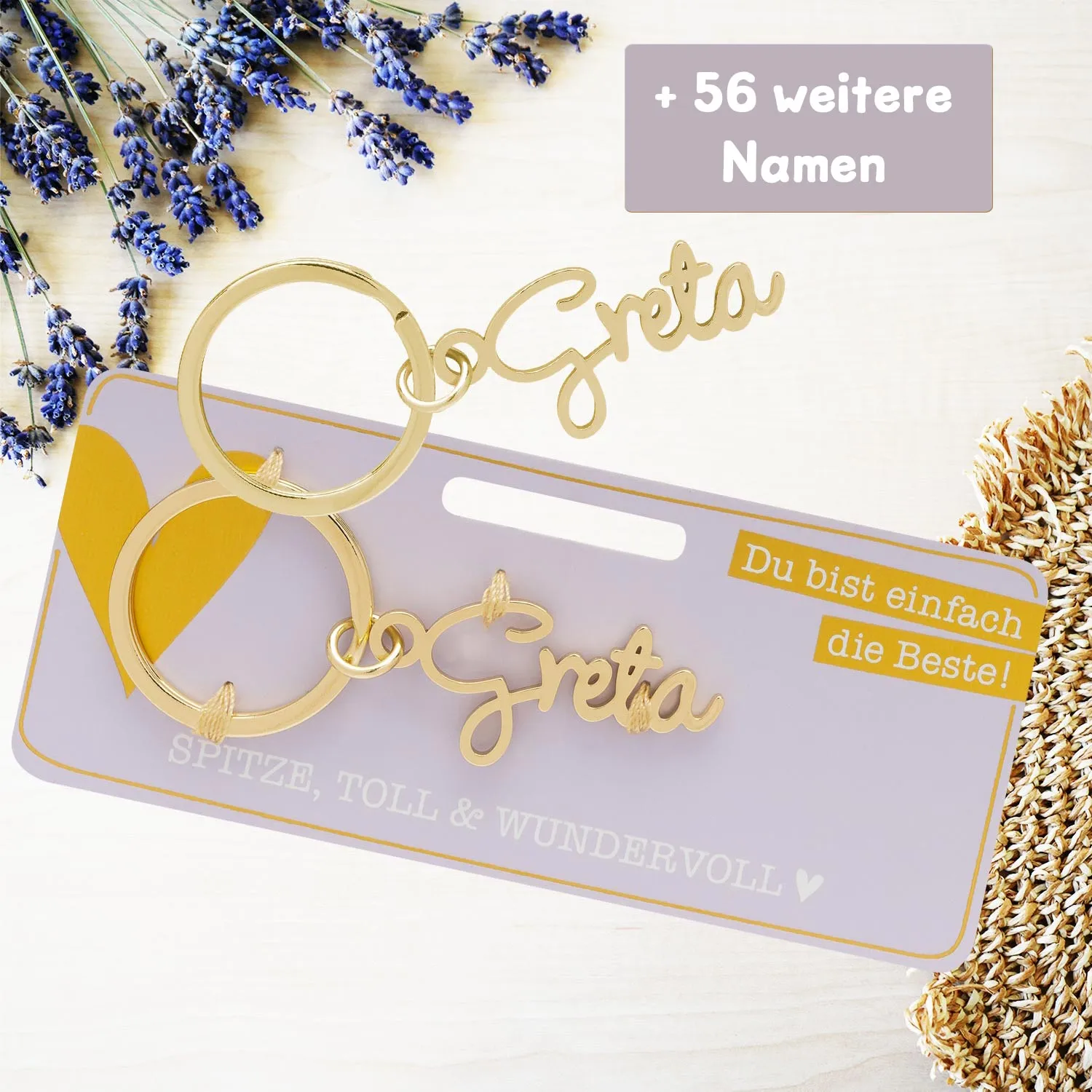 Goldfarbener Namens-Schlüsselanhänger Greta aus Metall mit Namenszug und zwei Ringen.